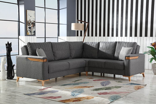 Grafitowa narożna sofa w przestronnym salonie z dywanem geometrycznym